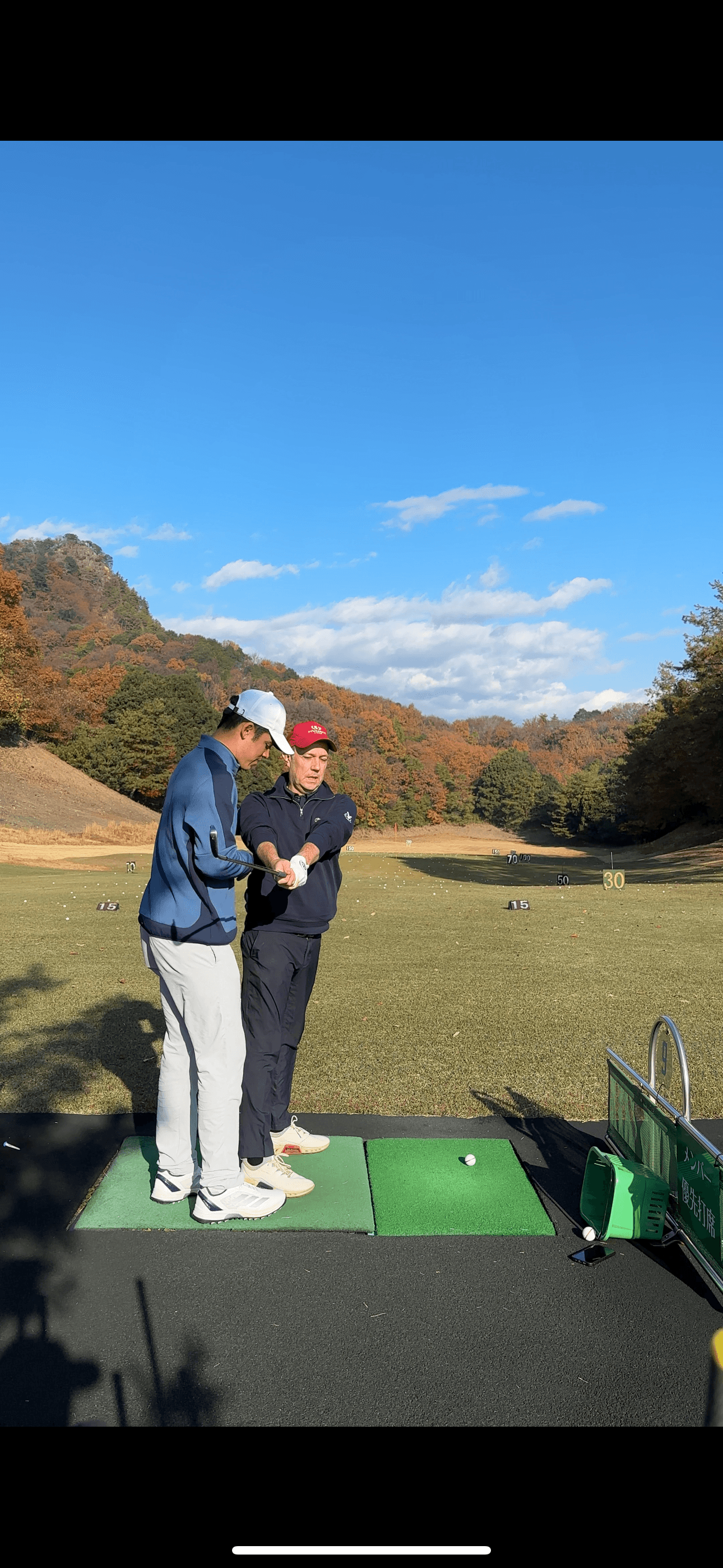 Driving range coaching session in autumn