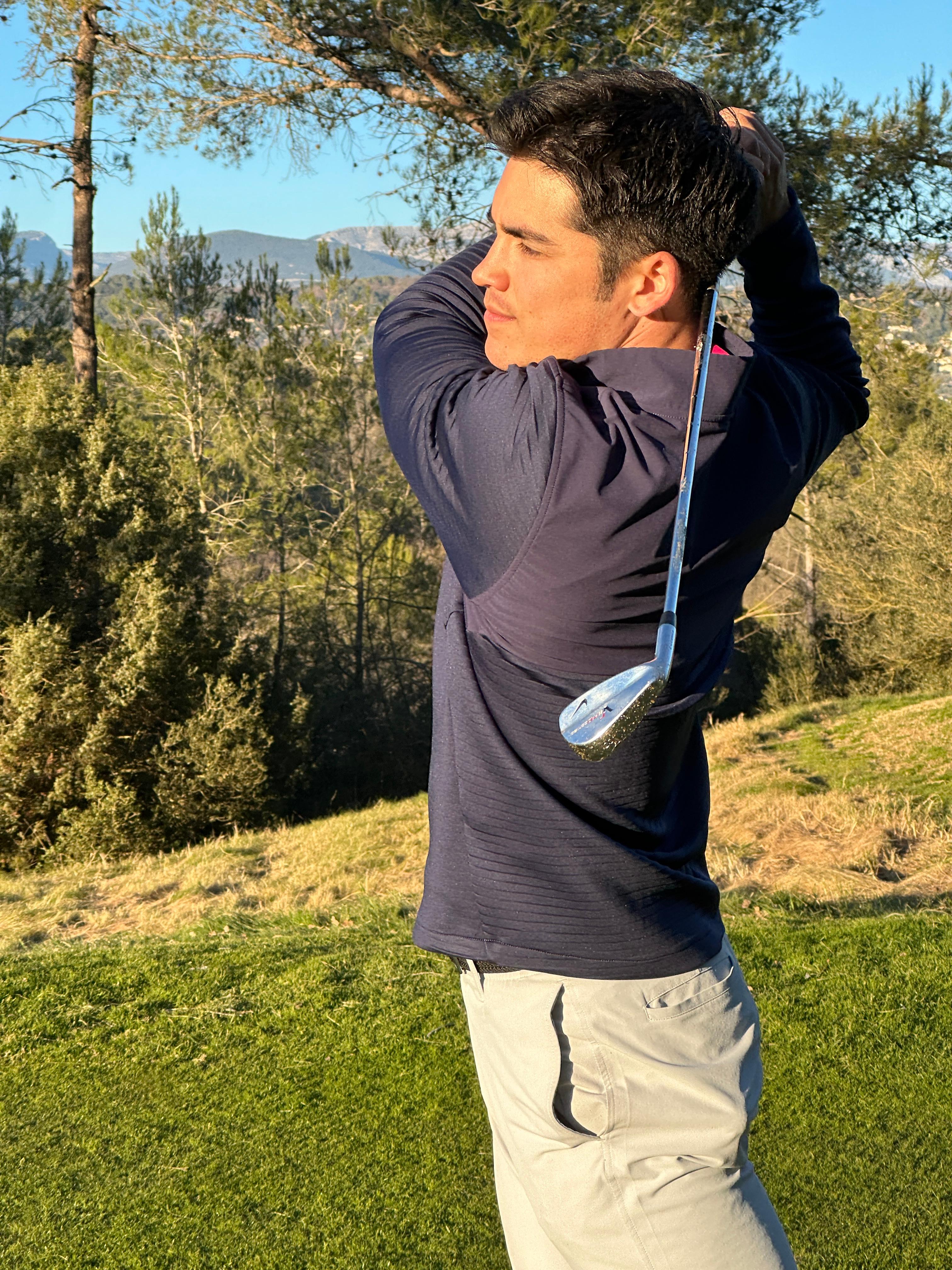 Louis mid-swing with Mediterranean scenery